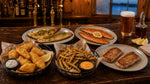 Pub Basket Sampler cooked and served on a tavern bar: fried walleye, seared rainbow trout, beer battered walleye strips, breaded green beans and pork chops